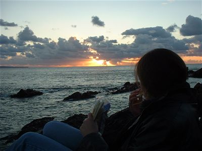 Audrey eating naan bread with a lovely sunset