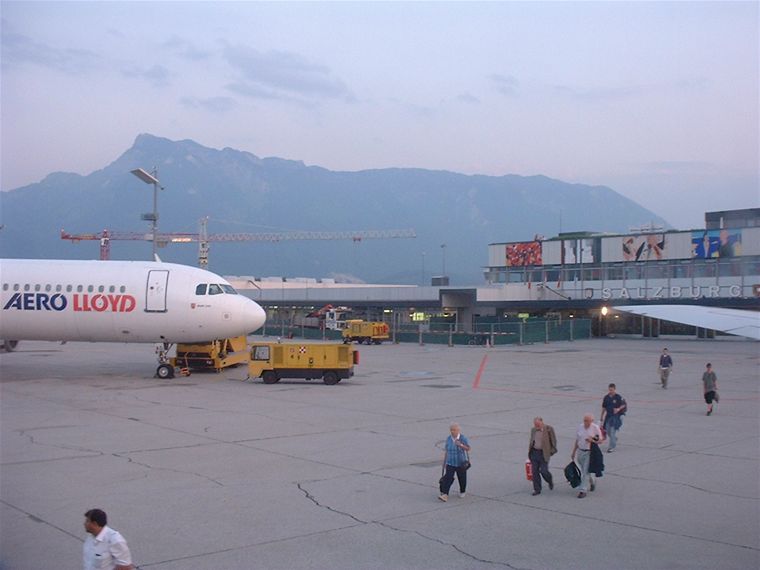 The view from the plane as people are getting on it, the Alps starting in the background